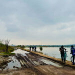 Bikers along body of water