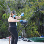 Woman controlling a winch with electronic equipment